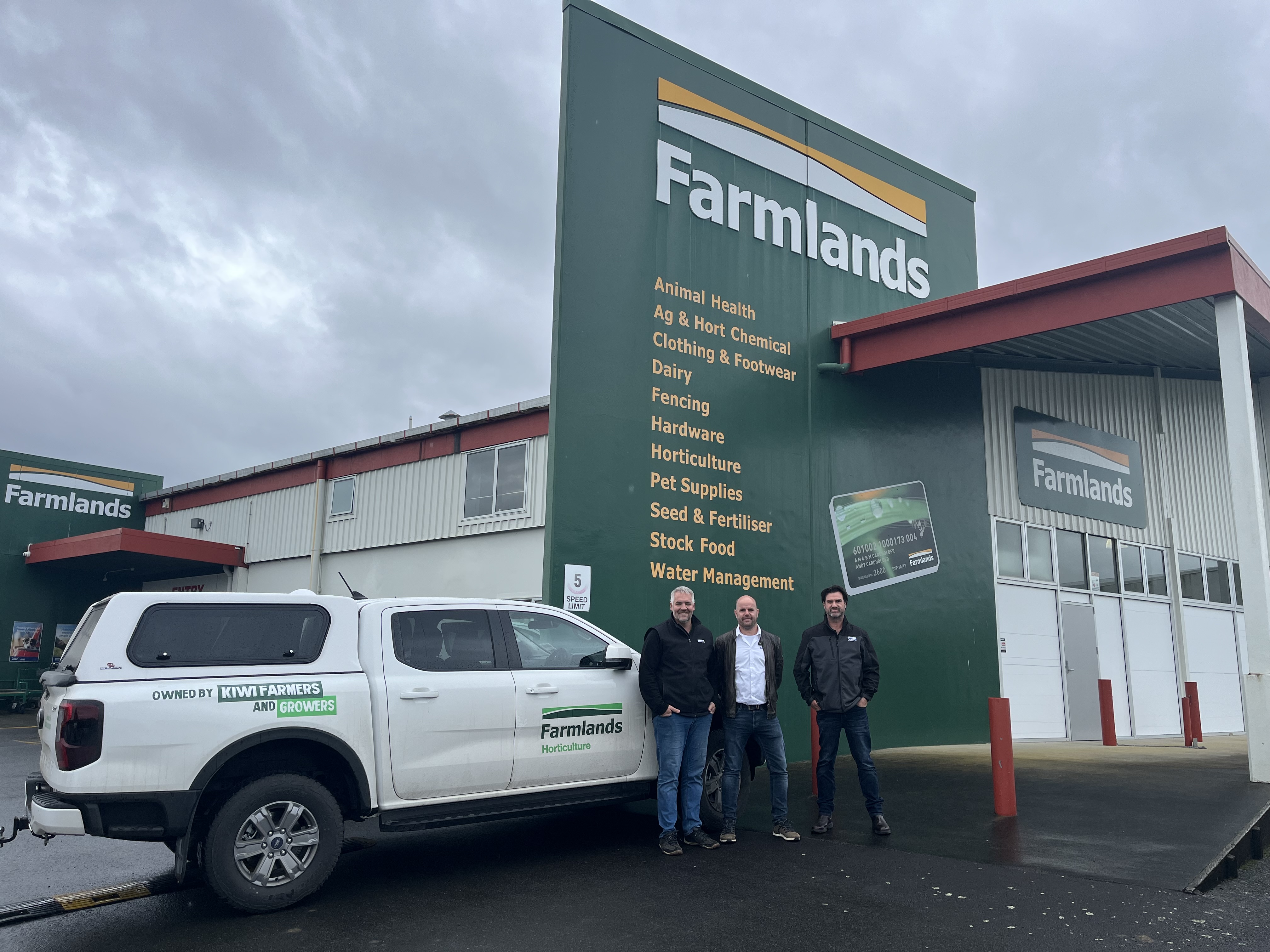 Team in front of Farmlands building